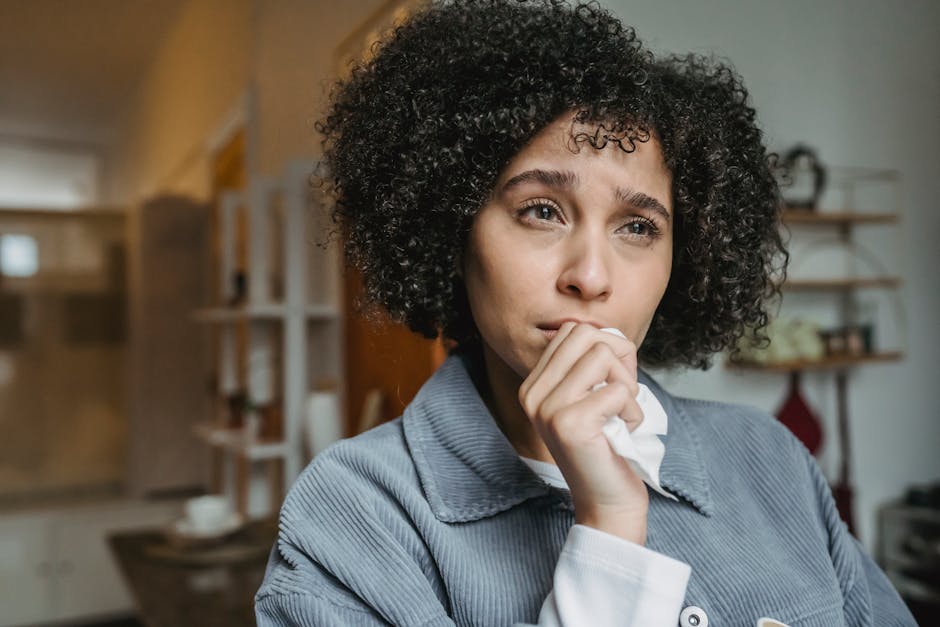 pexels-photo-6382601-6382601 Portrait of a young woman with curly hair expressing sadness indoors.